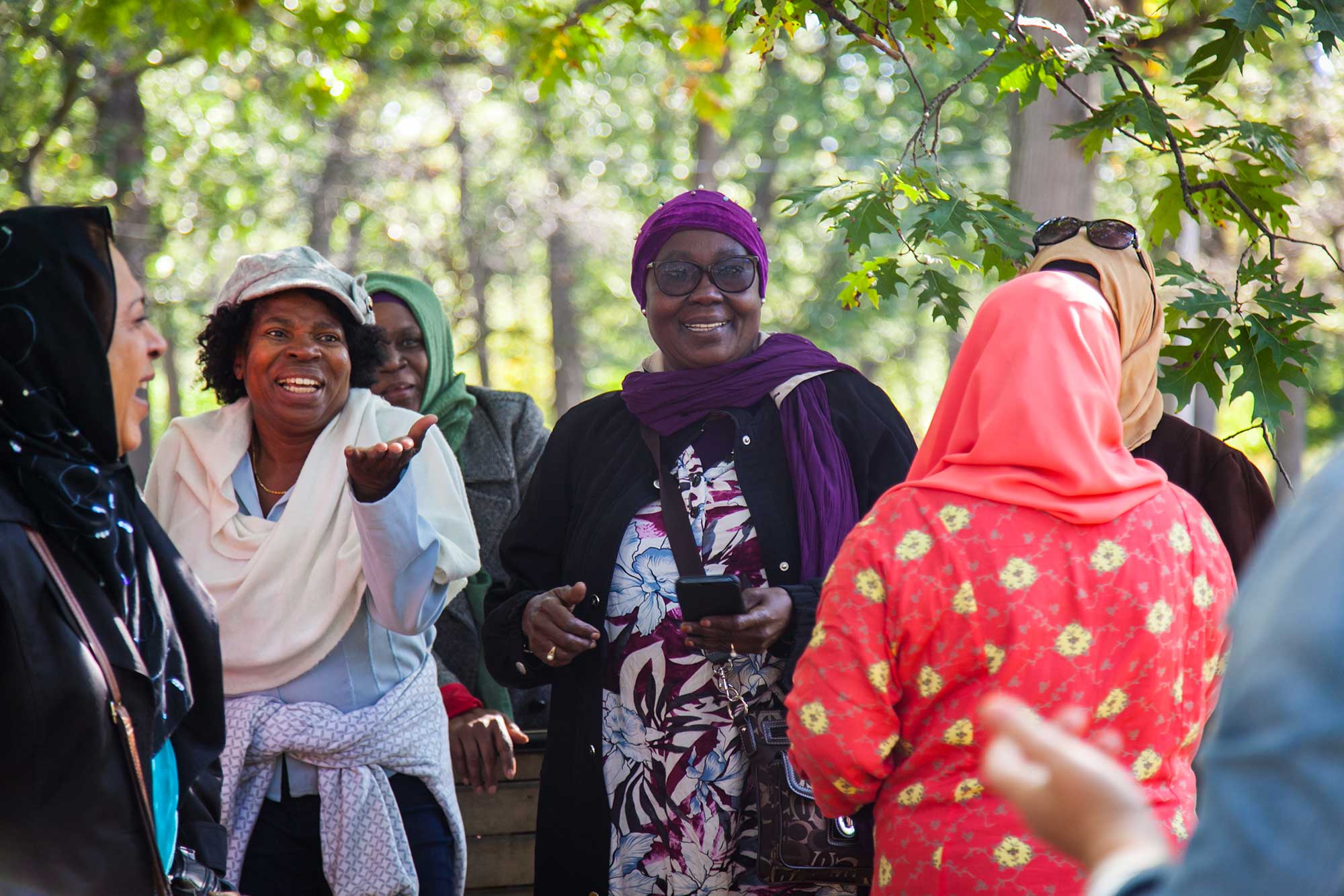 Black women laughing in a park