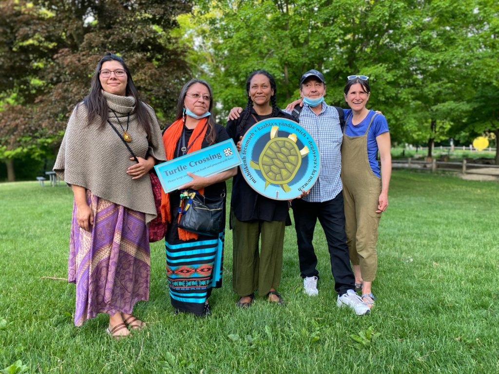 5 people standing with a log "Turtle protectors"